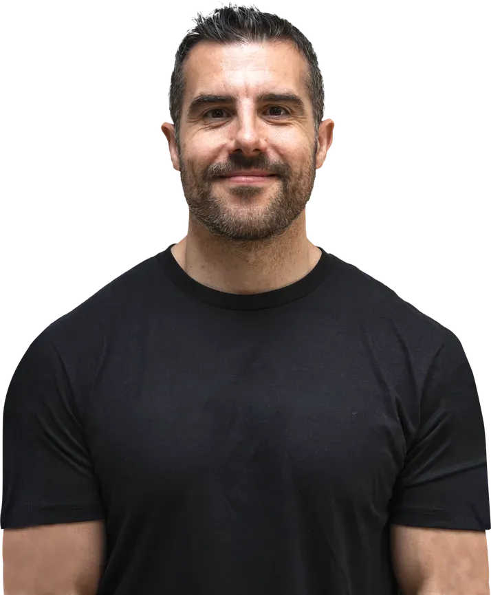 Gavin Attorre, performance coach, smiling in a black t-shirt.