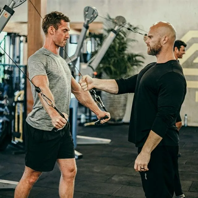 Ben coaching a client on cable technique