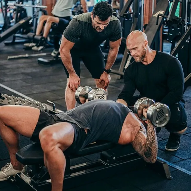 Ben spotting a client during dumbbell press