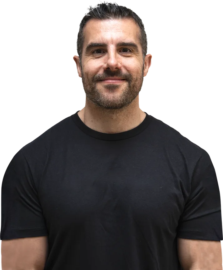 Gavin Attorre, performance coach, smiling in a black t-shirt.